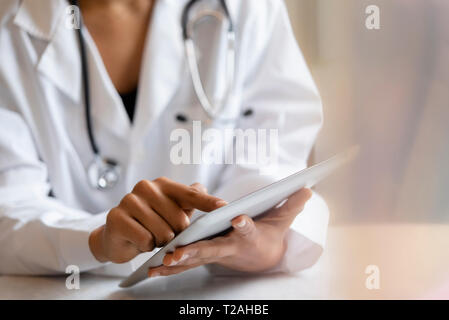 Doctor using digital tablet Stock Photo