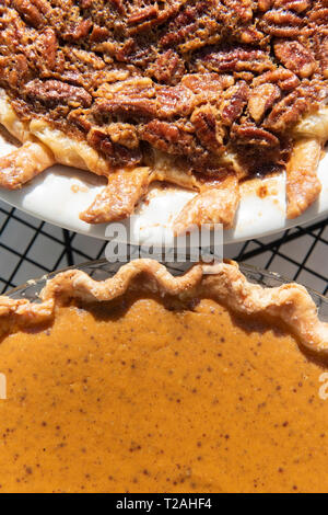 Pumpkin and pecan pies on a cooling rack Stock Photo