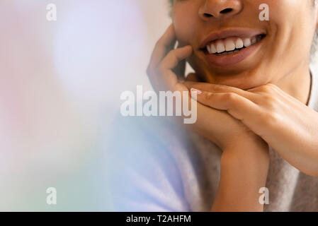 Young woman with hands clasped Stock Photo