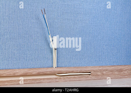 Close-up of cable channel with copper wires of PVC plinth. Stock Photo