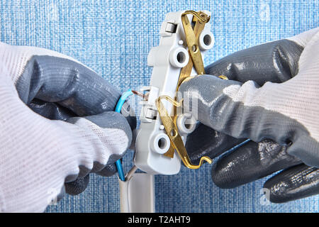 Inserting copper wiring in electric plug house wiring, electrical installation. Stock Photo