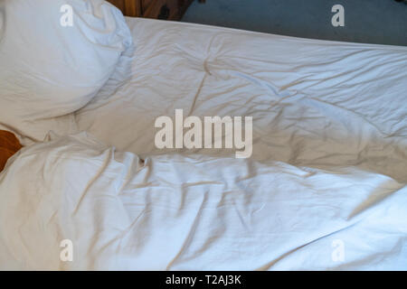 High up view from above of a bedroom in the morning scene with a vacated unmade double bed in a luxury bedroom Stock Photo