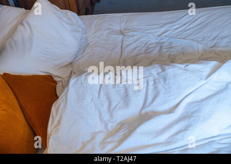 High up view from above of a bedroom in the morning scene with a vacated unmade double bed in a luxury bedroom Stock Photo