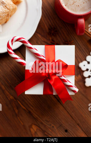 Christmas present with red ribbon and candy cane Stock Photo