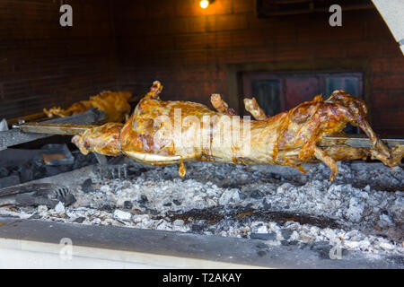 Lamb being roasted whole on a spit Stock Photo