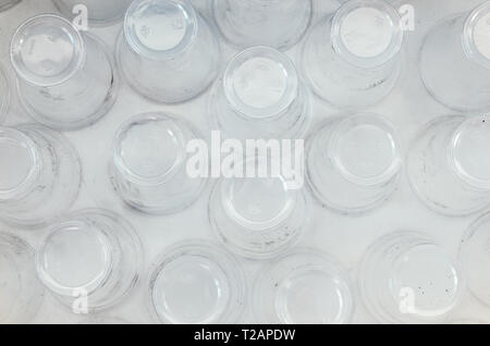 A lot of plastic cups, top view, white background. Increasing the amount of plastic concept. Non-compostable waste Stock Photo