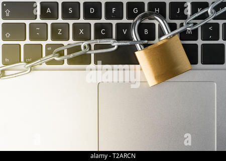 Padlock with chain on a laptop computer keyboard. Cyber security abstract concept. Stock Photo