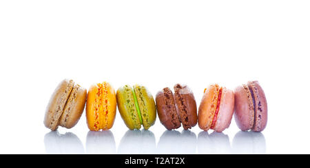 Row of pastel colored french macarons, on white background Stock Photo