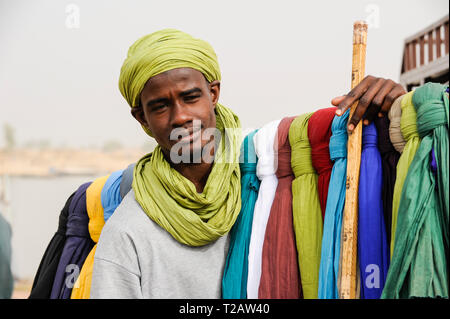 MALI Mopti, street hawker sells coloured cloth for use as shesh or Tagelmust, the turban of Touareg, Haussa and Songhai Stock Photo
