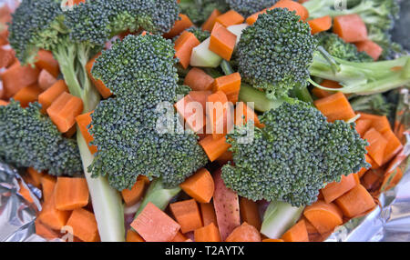 Freshly sliced & diced carrots (Daucus carota), broccoli florets (Brassica oleracea) red potato (Solanum tuberosum)  prepared for vegetable soup, Stock Photo