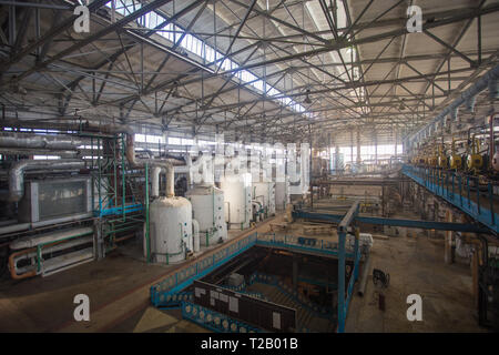 Theme industry and processing of agricultural crops. Equipment and machinery inside the old sugar factory of Soviet times Stock Photo