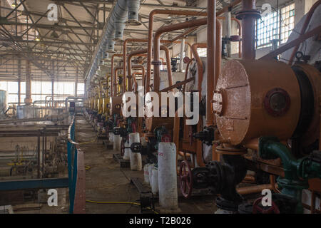Theme industry and processing of agricultural crops. Equipment and machinery inside the old sugar factory of Soviet times Stock Photo