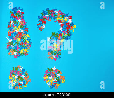 figure of an exclamation mark and a question mark from multicolored letters on a blue background, copy space Stock Photo