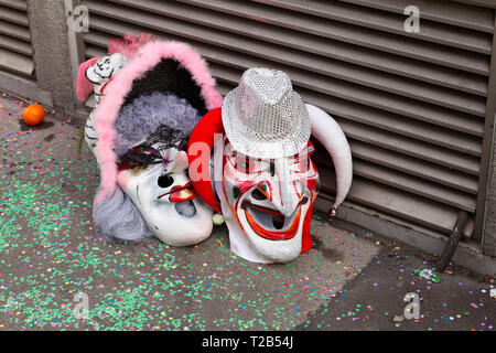 Baeumleingasse, Basel, Switzerland - March 12th, 2019. Close-up two carnival masks laying on the ground Stock Photo