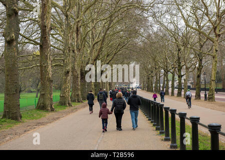 LONDON, UK - MARCH 22, 2019: Tourists walking through the alleys of the Green Park in Wesminter city, London Stock Photo