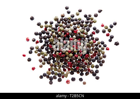 Mixed peppercorns on white background. Different colored peppercorns, close up. Stock Photo