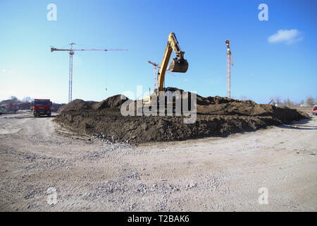 Bucharest, Romania - March 19, 2019: Excavator and other heavy machines working on a construction site Stock Photo