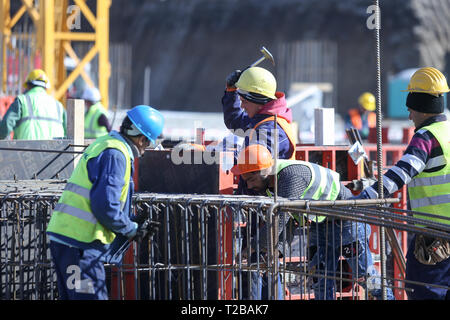 Bucharest, Romania - March 19, 2019: Workers on a construction site Stock Photo