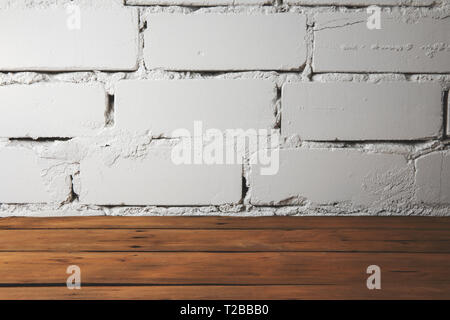 old plank wooden floor with white brick wall Stock Photo