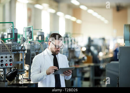 Handsome Factory Manager Using Tablet Stock Photo