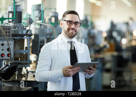 Handsome Factory Manager Holding  Tablet Stock Photo