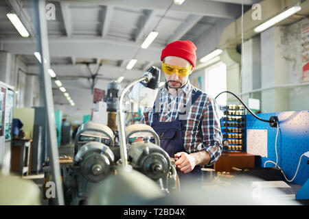 Factory Worker using Machines Stock Photo