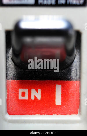 Vintage safety switch in on position, isolated on white background, close-up Stock Photo