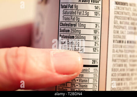 A dieter studies the carbohydrate count in an Atkins milk chocolate delight ready-to-drink shake, March 17, 2019, in Coden, Alabama. Stock Photo