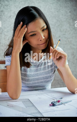 Engineer working on blueprint Stock Photo