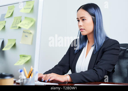 Businesswoman working on computer Stock Photo