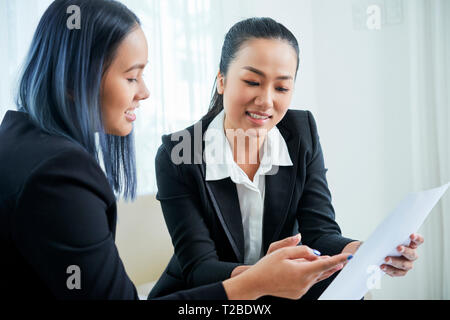 Business partners discussing contract details Stock Photo