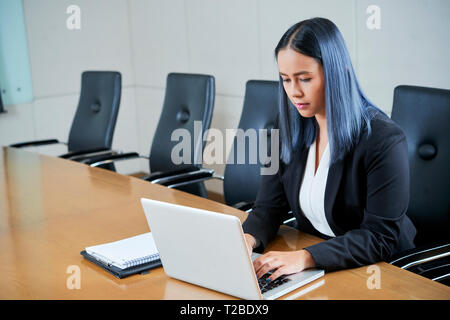 Businesswoman working on laptop Stock Photo