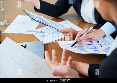 Business discussing financial statistics Stock Photo