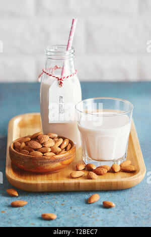 Vegan substitute dairy milk. Glass with non-dairy milk and ingredients. Stock Photo