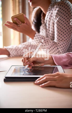 Businessman writing on tablet computer Stock Photo