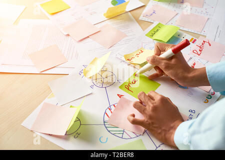 Businessman sticking notes on documents Stock Photo