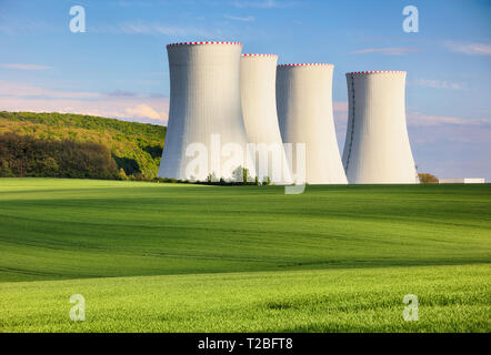 Nuclear power plant with green field.