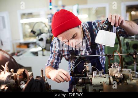Worker Repairing Machines at Factory Stock Photo