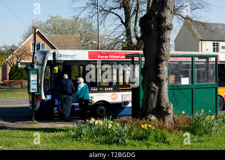 A local bus at a bus stop in High Street, Hillmorton, near Rugby, Warwickshire, UK Stock Photo