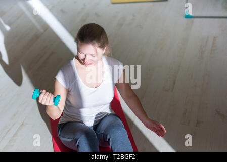 portrait of young obese woman working out home Stock Photo