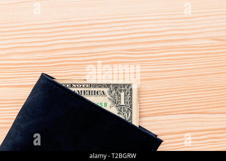 One dollar bill in leather wallet on the table, selective focus Stock Photo