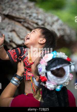 Baan Tong Luang Chiang Mai Thailand April 16 2018 young girl picks up happy bay Long neck Karen Traditional Village Stock Photo