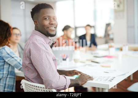 Young African Man Posing in Office Stock Photo