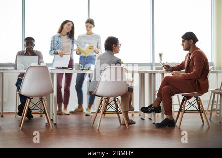 Diverse group of contemporary business people working at table in office, copy space Stock Photo