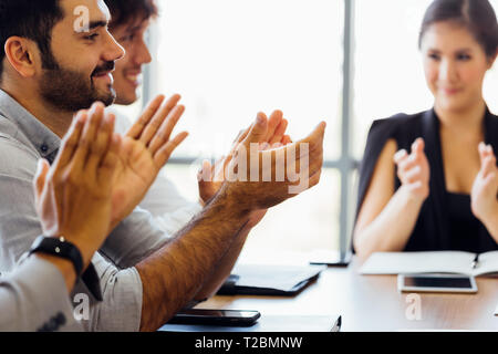 Closeup of businesspersons clapping hands and applauding in business meeting conference - woman power in corporate work Stock Photo