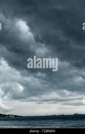 storm cloud background during raining. Dark Clouds. Huge black clouds on dark sky before a thunder-storm. Stock Photo