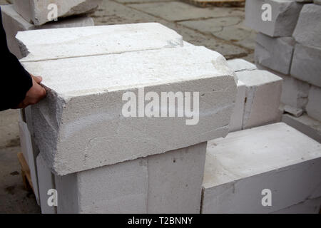 Mason checks autoclaved aerated concrete blocks at a factory Stock Photo