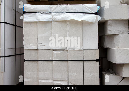 New aerated concrete blocks on pallets stored outdoors Stock Photo