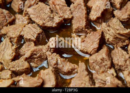 veal meat stew in a skillet with vegetables in sour cream sauce Stock Photo