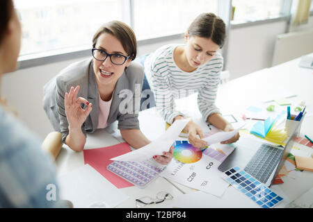 Portrait of two contemporary women discussing design ideas with creative team, copy space Stock Photo